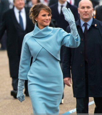 Melania Trump embodying individuality and rare elegance in a structured light blue luxury ensemble